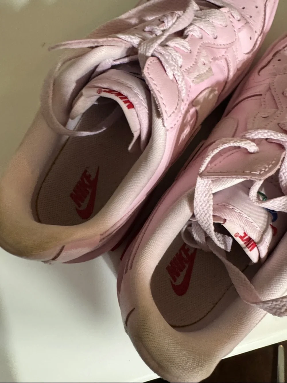 Nike Women’s Pink Low-Top Sneakers with Red Accent